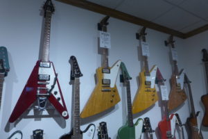 A 1959 Gibson Explorer hangs next to a 1991 reissue in Dave Roger's personal collection at Dave's Guitar Shop.