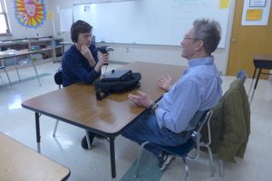 MG21 student Harrison Farnam interviews Vietnam veteran Bob Cook at school. (Maureen McCollum/WPR)