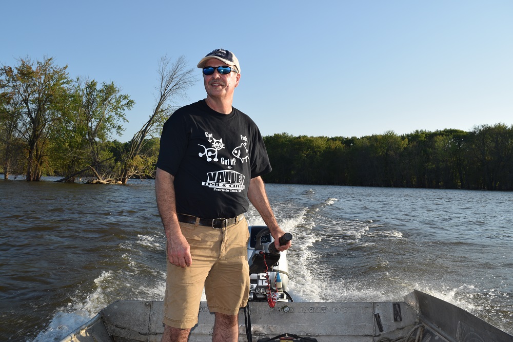 Mike Valley on his fishing boat on the Mississippi River. (Mary Kate McCoy/WPR)