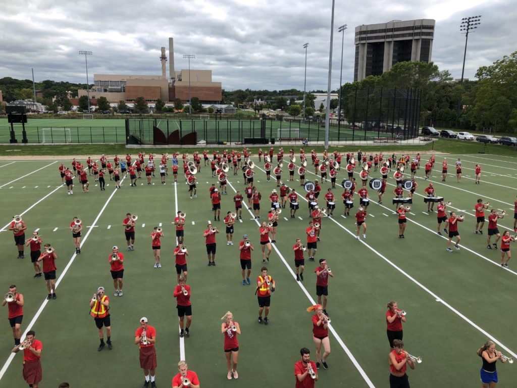 Three hundred UW-Madison undergrads fill the field marching and playing as they rehearse the band’s halftime show. (Tim Peterson/WPR)