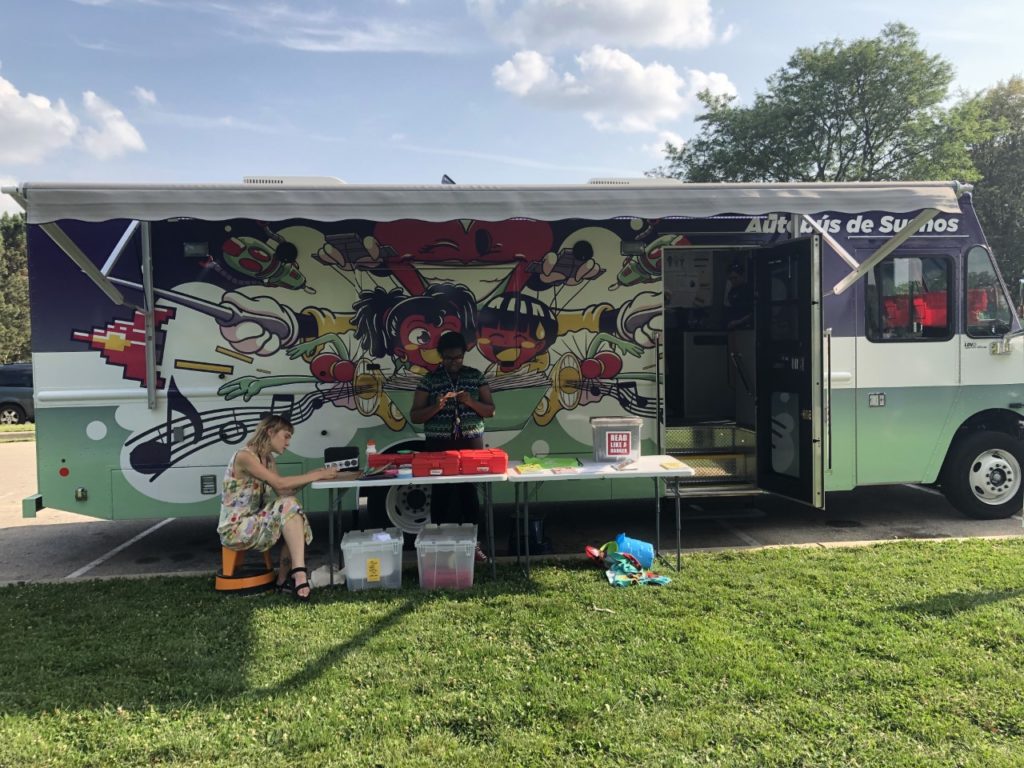 Madison Public Library's Dream Bus stops in different neighborhoods and brings books and media to people. (Jane Genske/WPR)