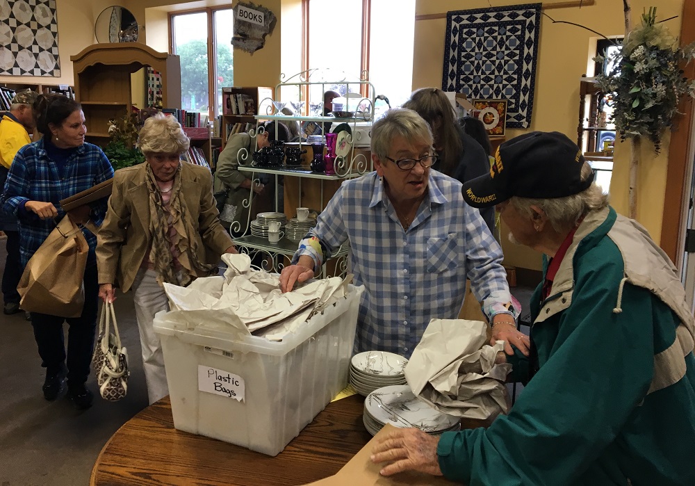 Store manager Jan Degner (in plaid shirt) helps customers. (Photo by Jane Hampton)