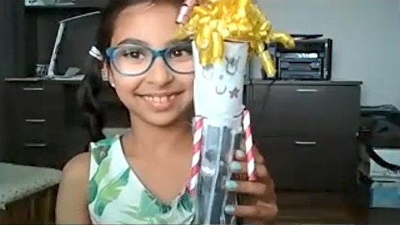 Gia, a Madison Country Day School third grade student, shows off her homemade doll, Sassy. She says it helps with her constant "fiddling." (Zoom Screen Shot)