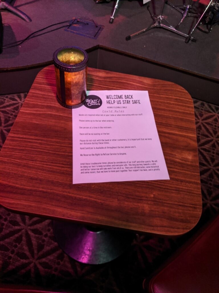 The Jazz Estate's "Covid Rules" on display at tables throughout the bar. (Photo by Andy Turner)